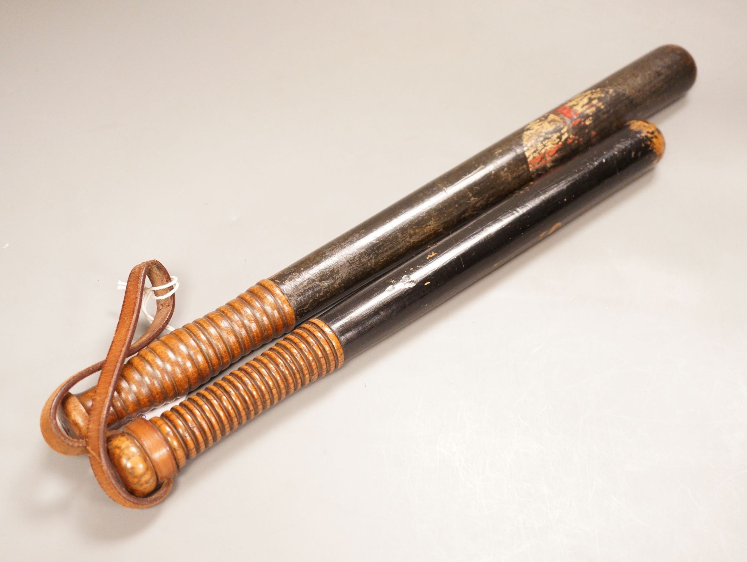 Two Victorian painted truncheons, one ‘Sergt. 21 E.S.C’, the other painted with St. George’s cross, 47cm